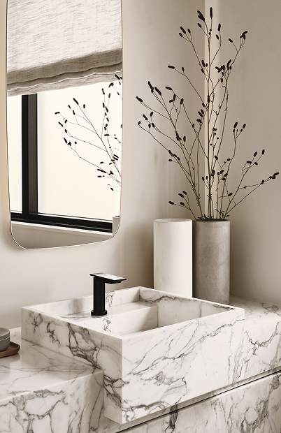 Minimal bathroom sink with stone countertop and decorative plants